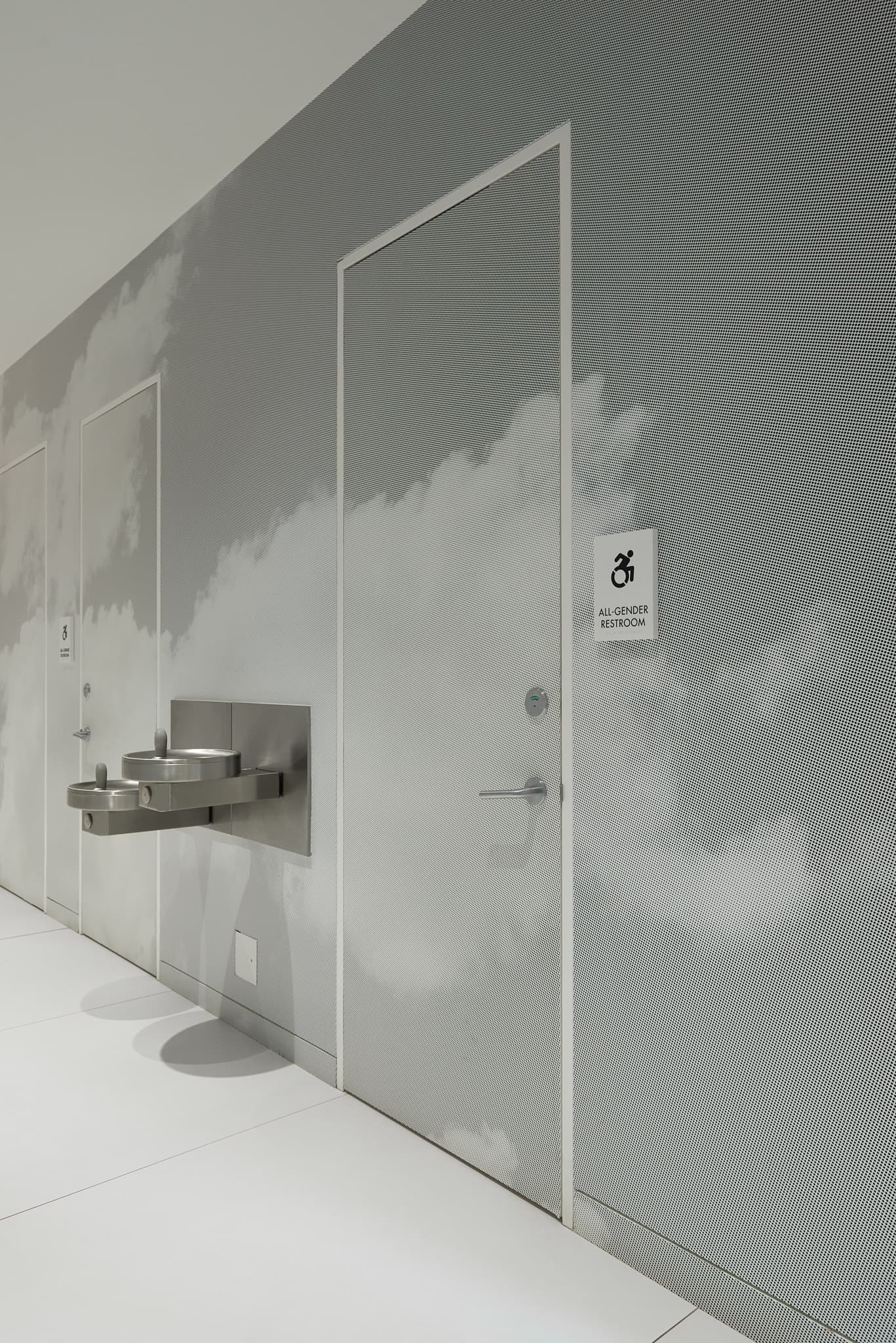 Photo of the grayscale halftone mural in the rear hallway, showing clouds in the sky