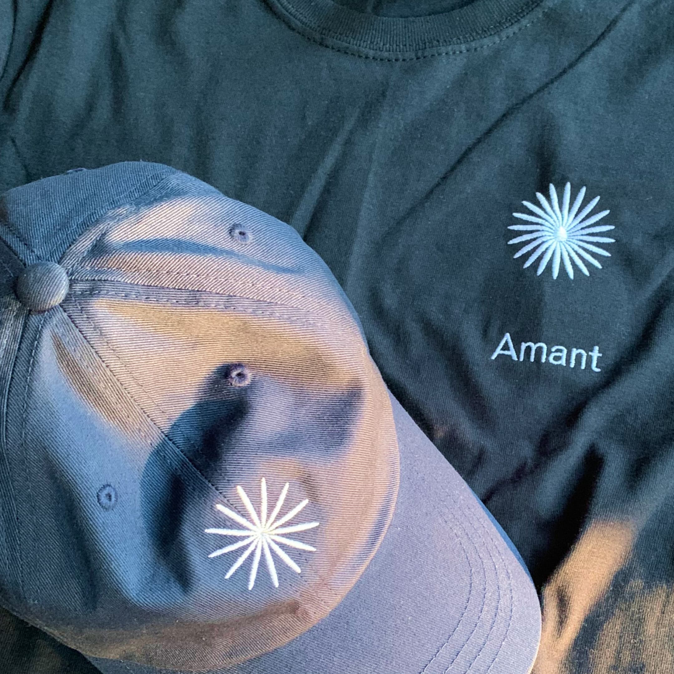 A hat and tshirt with the logo embroidered.